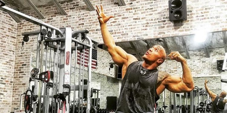 Dwayne Johnson posing in the gym